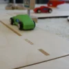 Close-up image of natural plywood toy road for model cars